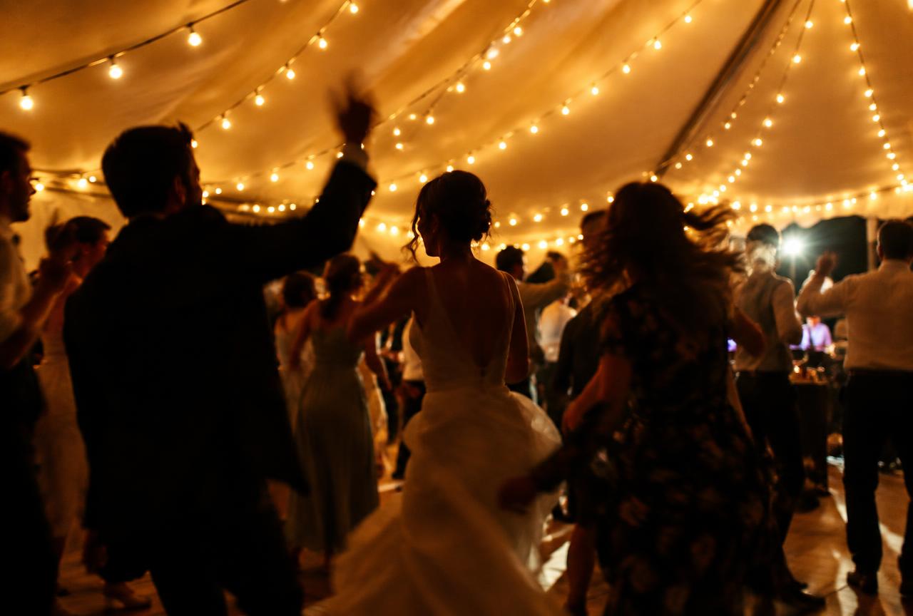 Guests dancing under festoon lights